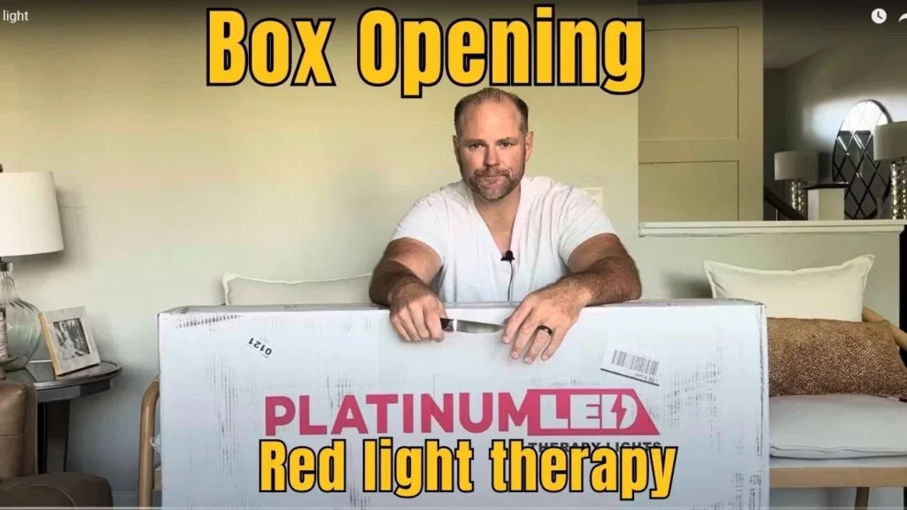 Unboxing Platinum LED Bio Max 900 red light therapy device showing large panel with 300 LEDs for home treatment.