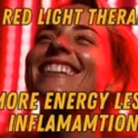 Smiling woman in front of red light therapy panel highlighting its benefits for energy and inflammation reduction.