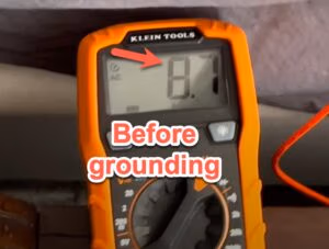 Voltage meter showing a reading of +1.6 volts before grounding, indicating the body's positive electrical charge when disconnected from the Earth.